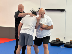 Adult students developing practical self defense skills through the Empire Method