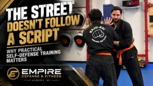 Adult self-defense students practicing realistic training at Empire Defense & Fitness in Albany NY